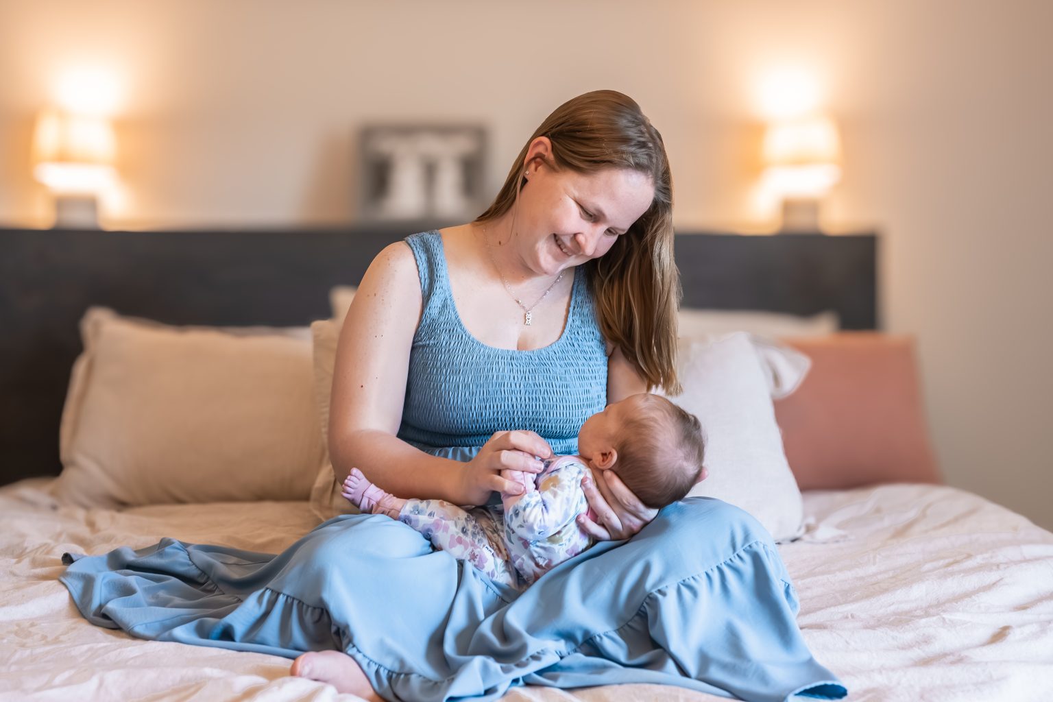Mother cradling her newborn during an in-home lifestyle session