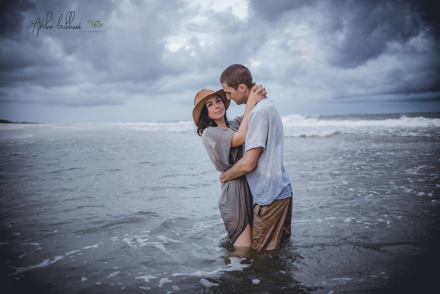 Couple embracing in the stormy surf
