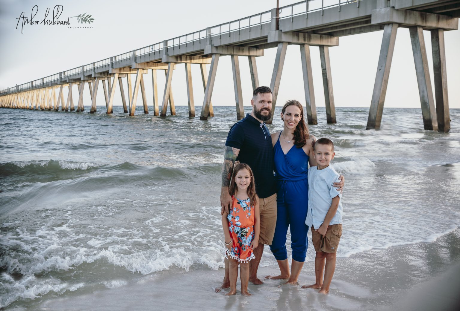 Family gathered beneath the Navarre Beach pier