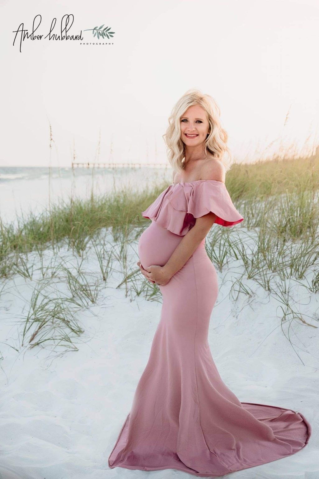 Maternity portrait in a blush gown among the sea oats