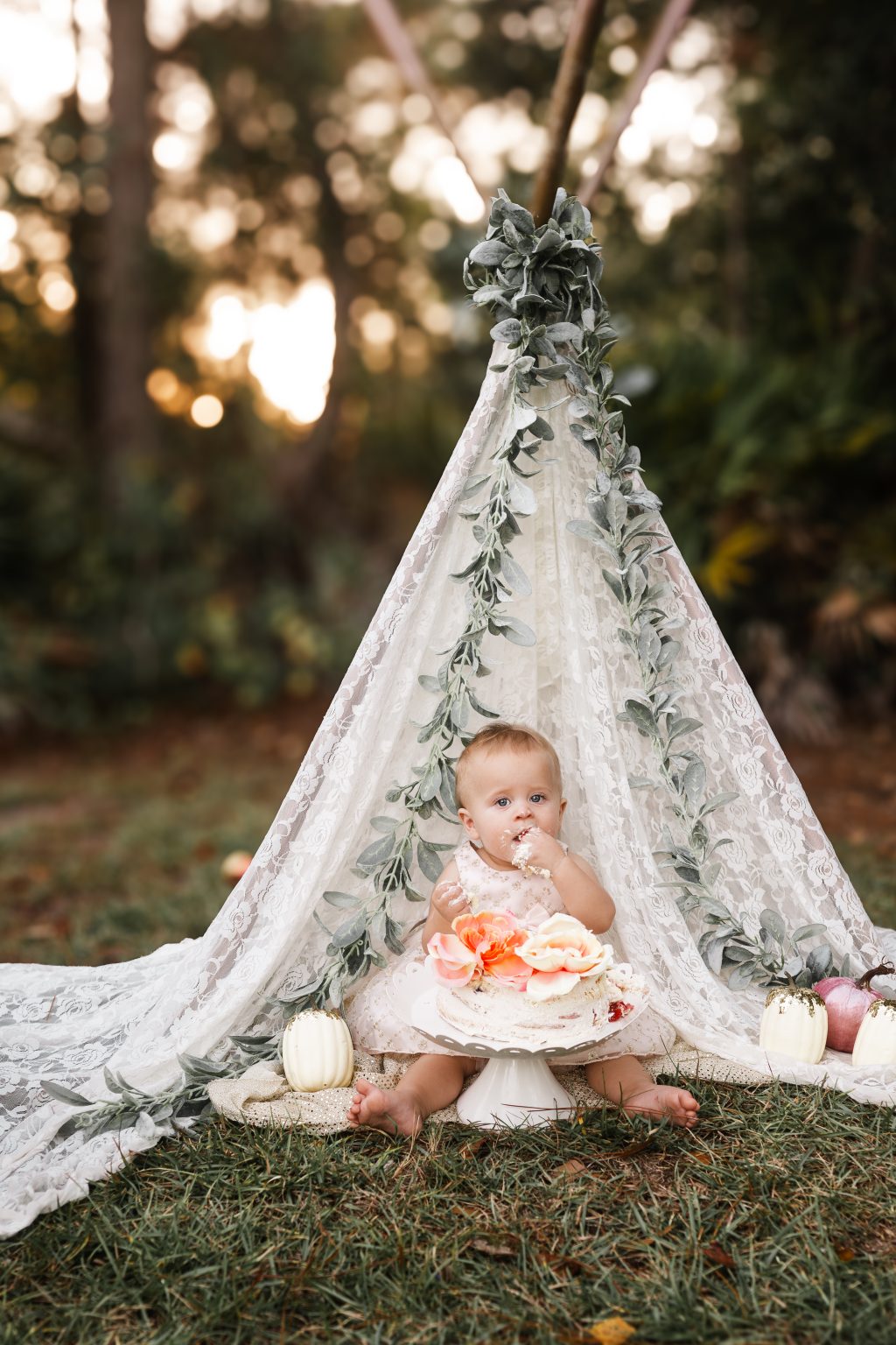 Baby beneath a floral canopy for a milestone session