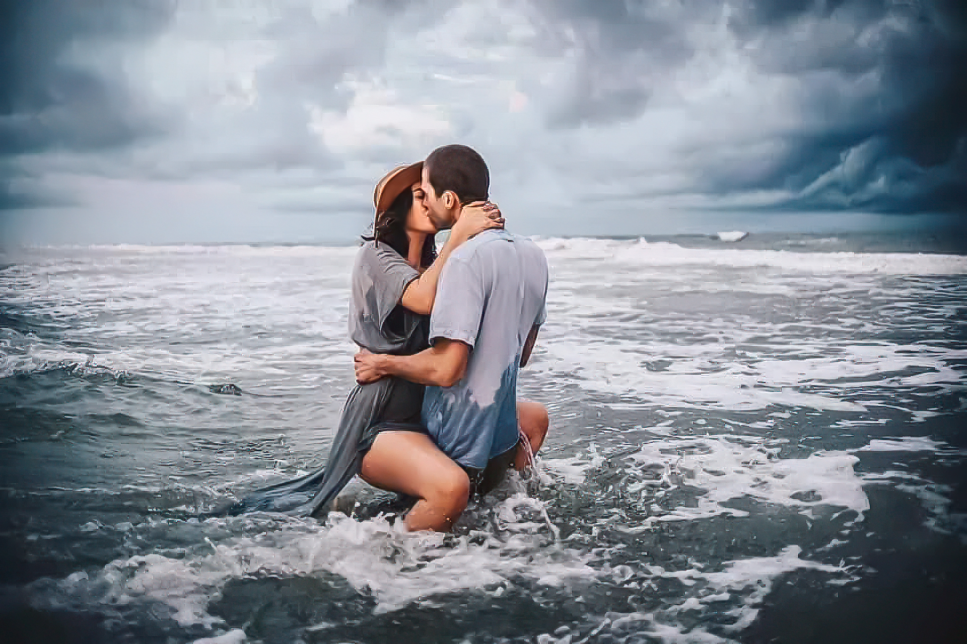 Couple sharing a kiss in the stormy surf beneath dramatic clouds