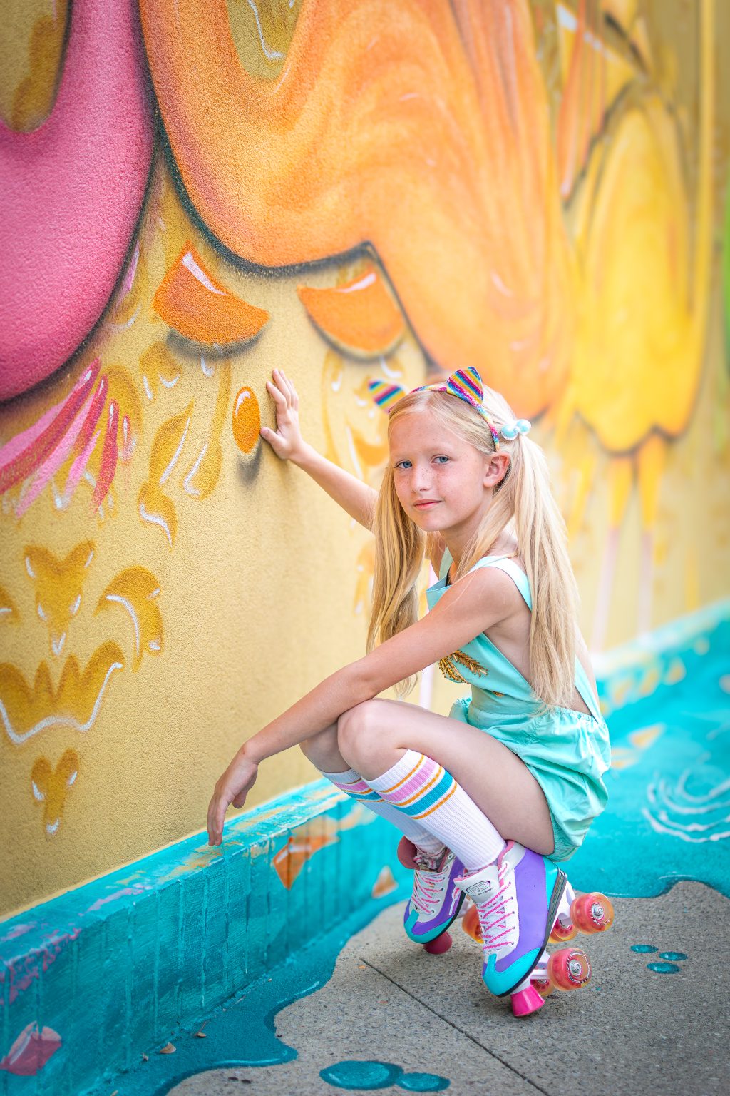 Roller-skate portrait against a colorful mural