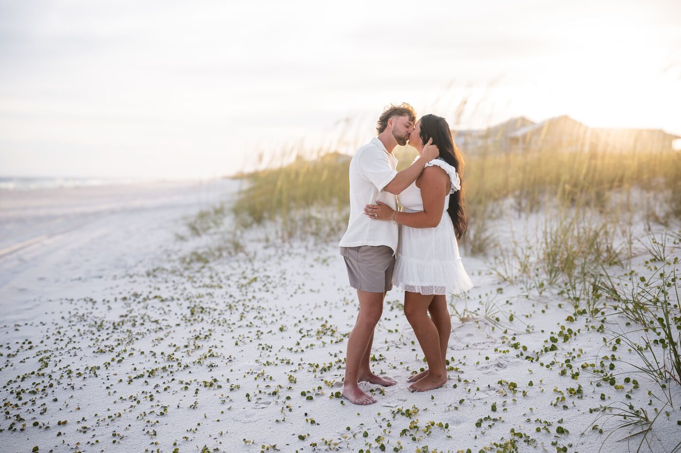 Newly engaged couple walking the wide open Navarre Beach shoreline
