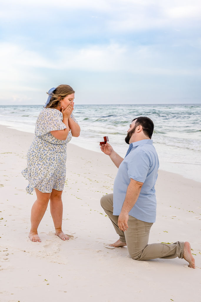 Surprise beach proposal on one knee at the Navarre Beach shoreline
