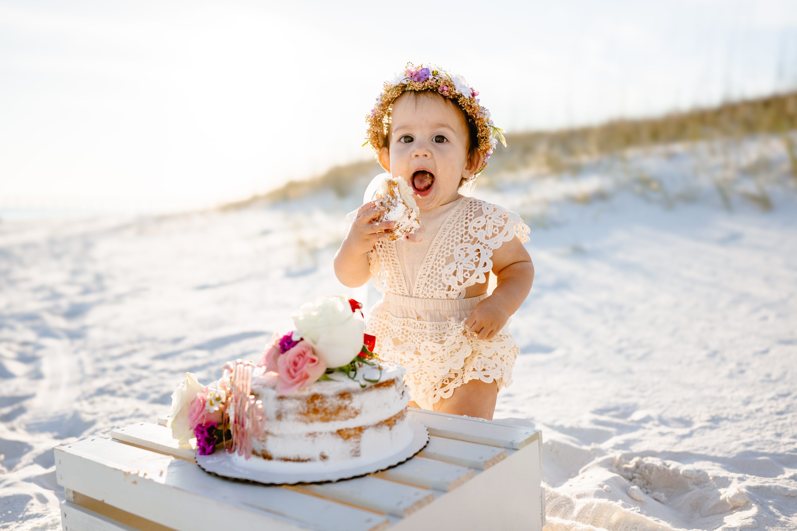 Navarre Beach cake smash photography — baby covered in frosting and smiles