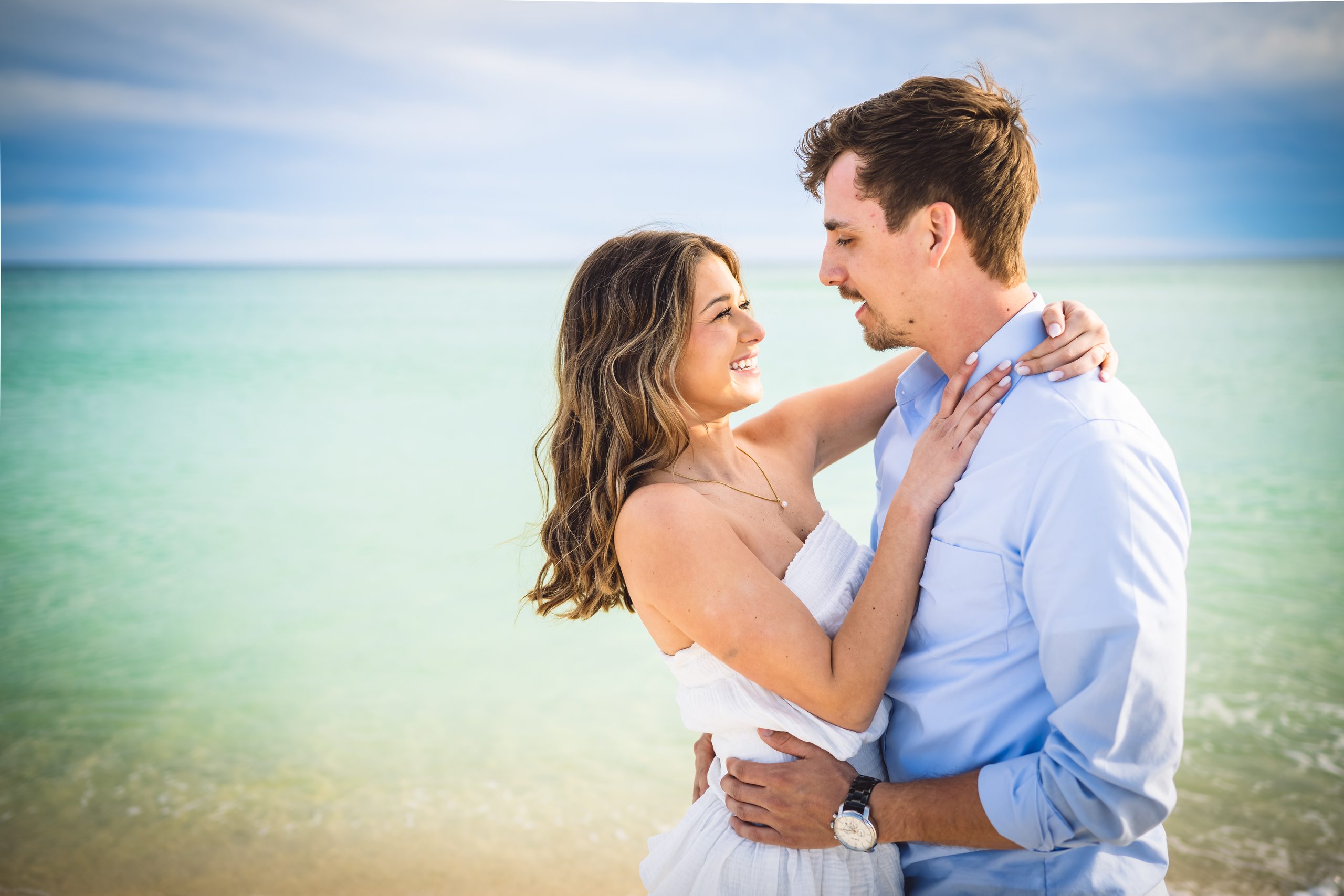 A surprise beach proposal captured at golden hour in Navarre Beach